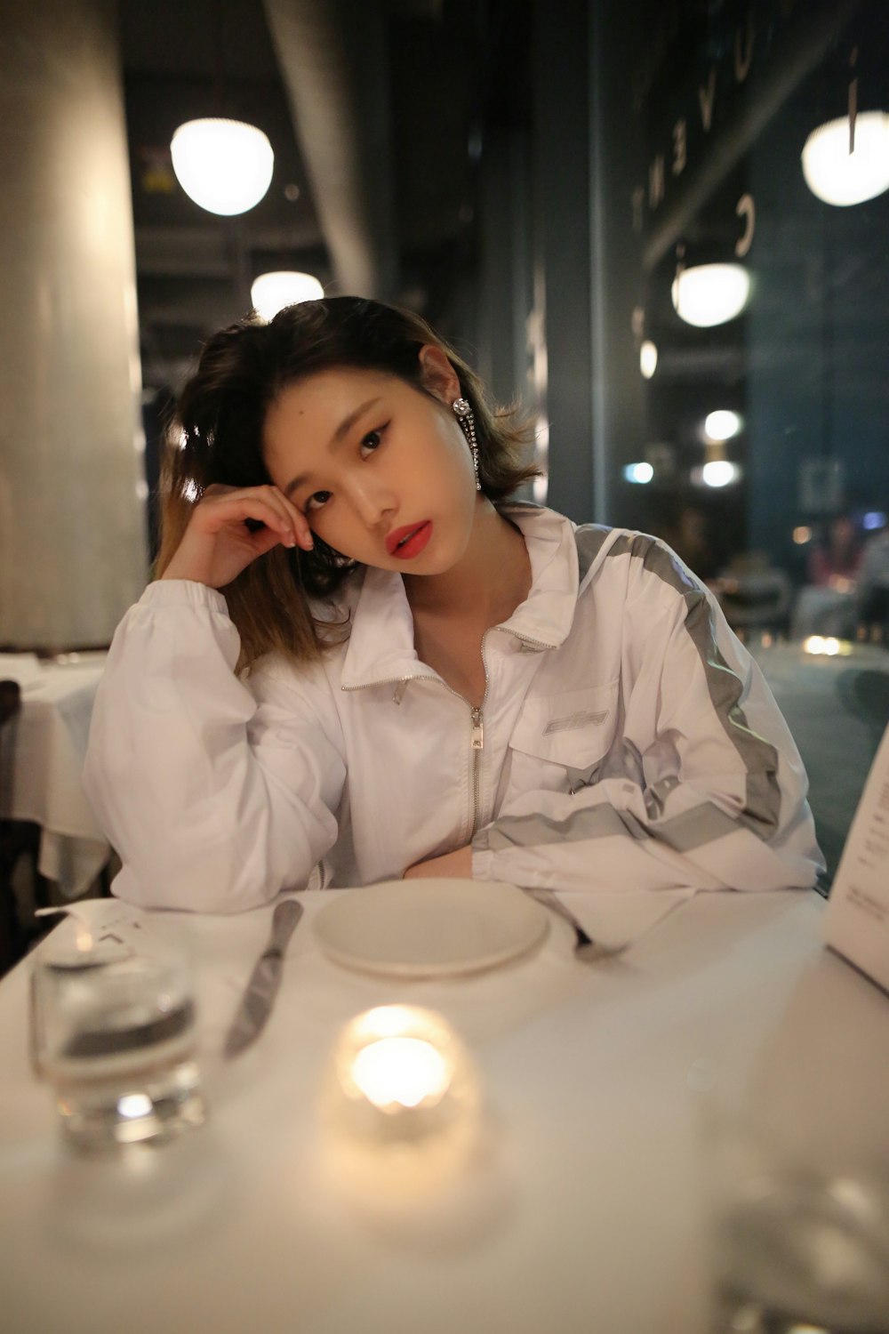 woman leaning on top of table