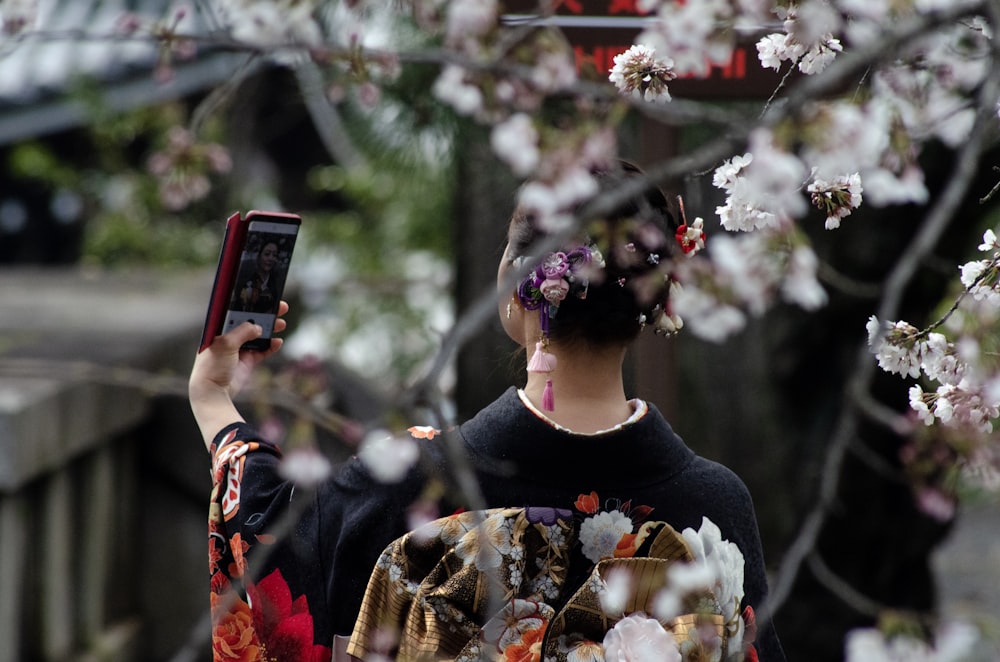 woman using Android smartphone outdoor during daytime