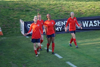 A group of friends smiling and cheering as they cross the finish line together.