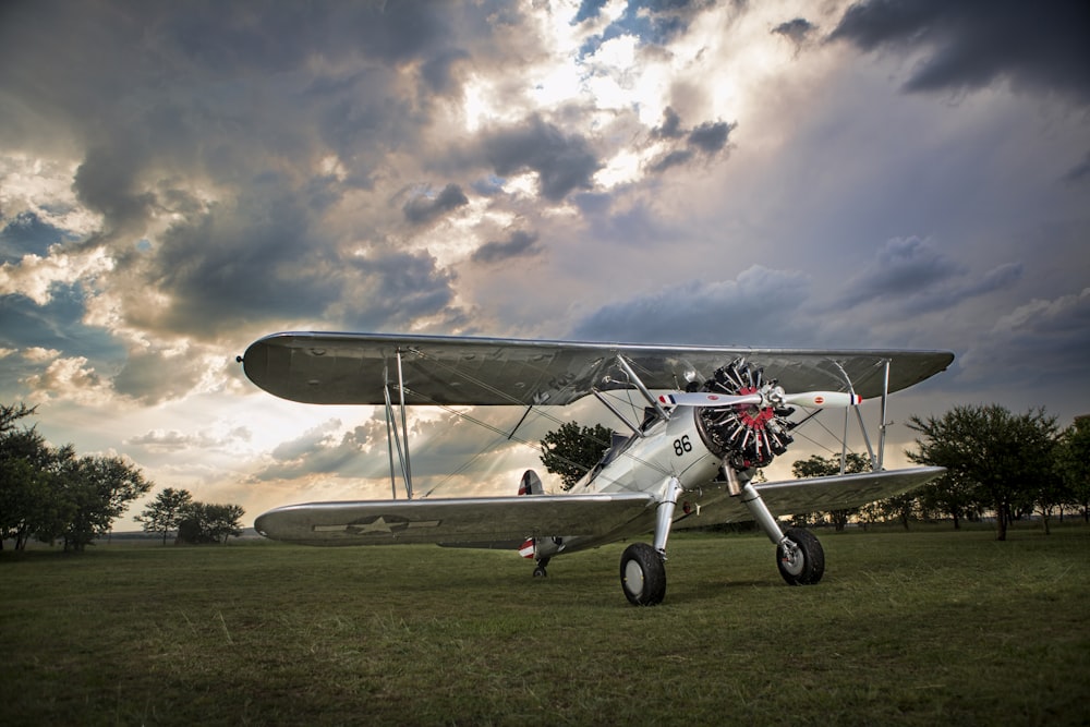 white biplane on green grass field