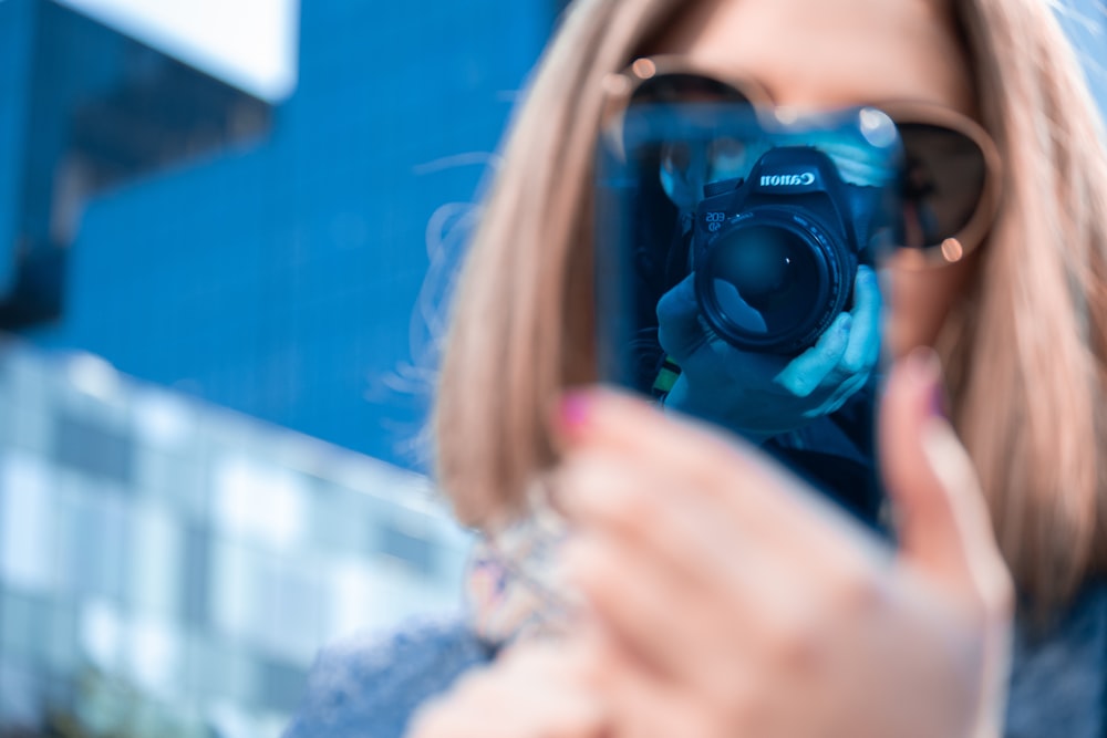 woman taking picture of her smartphone