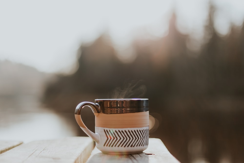 white and brown ceramic mug