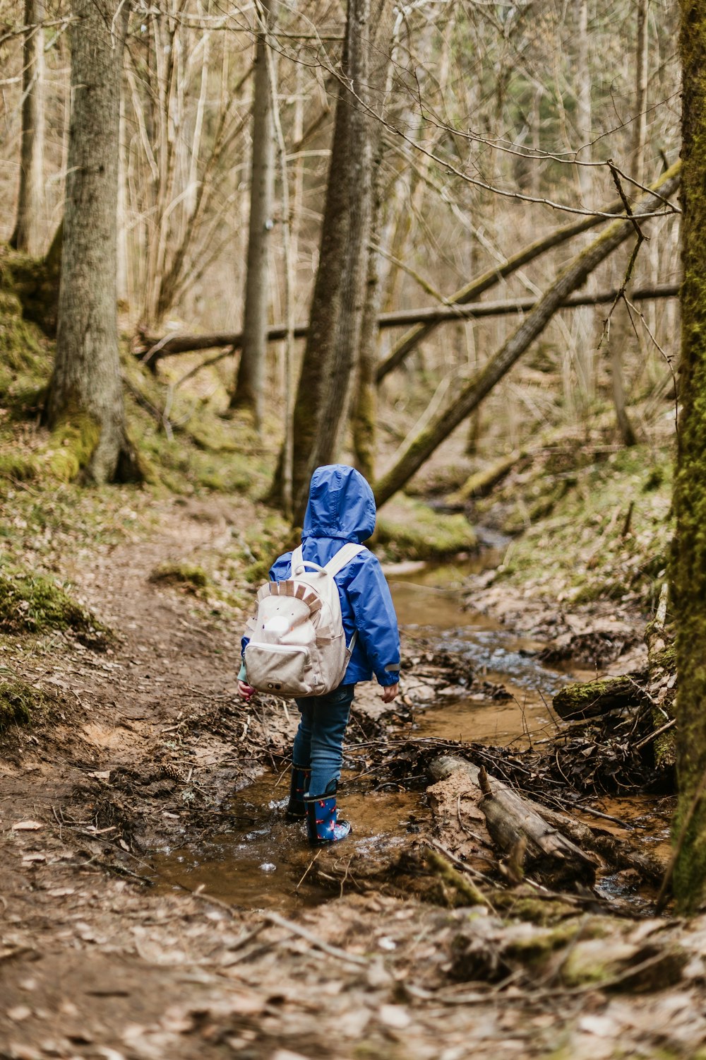 toddler walking under trees