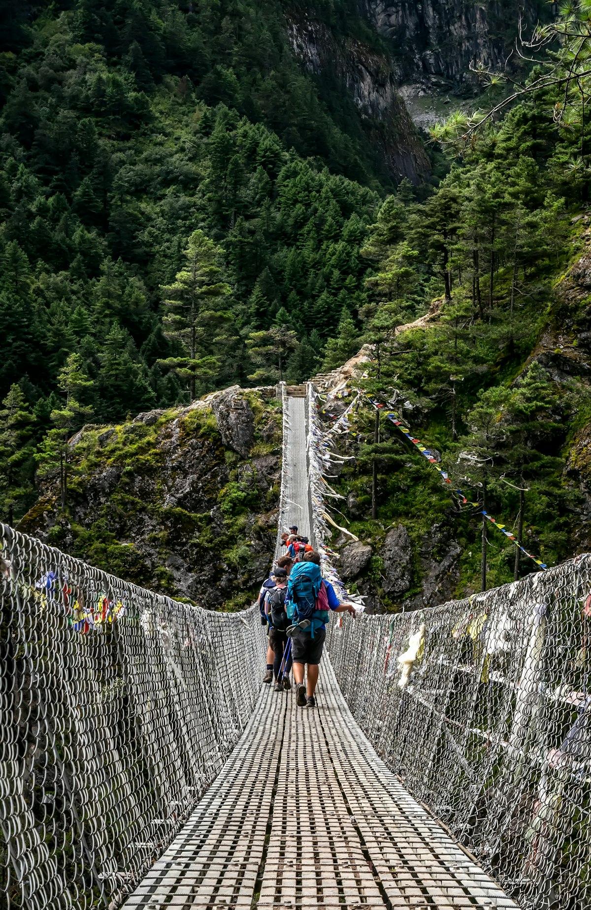 Trekkers crossing a mountain trail in Nepal