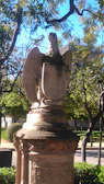 Outdoor animal figurine perched gracefully on a garden stone.