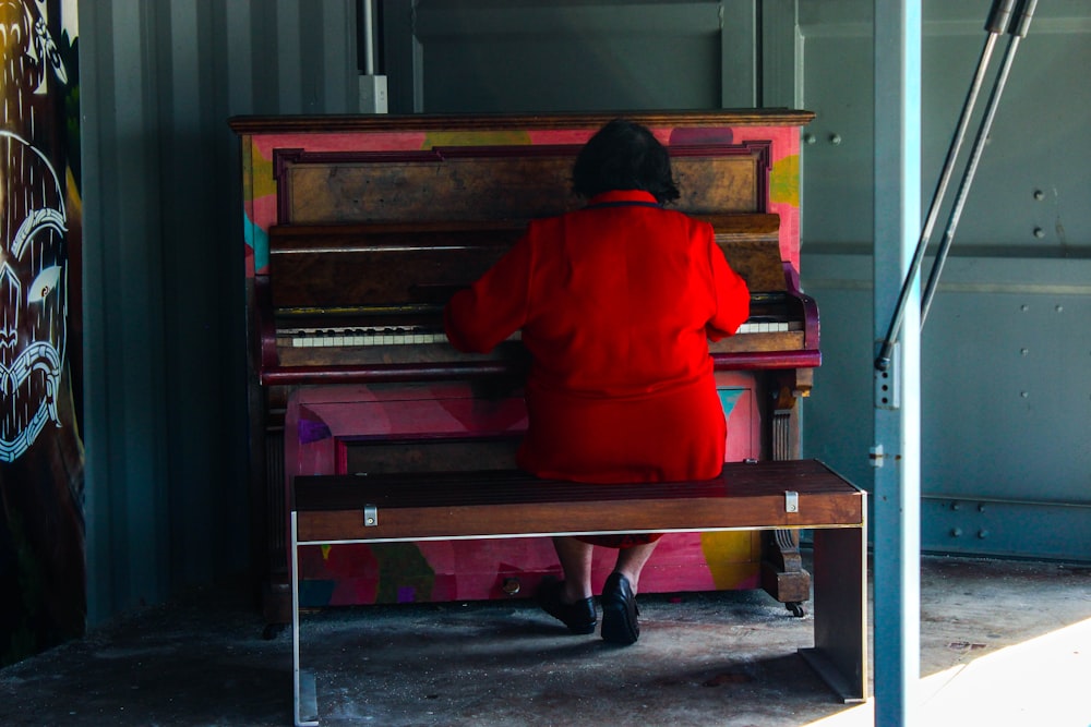 sitting person playing piano