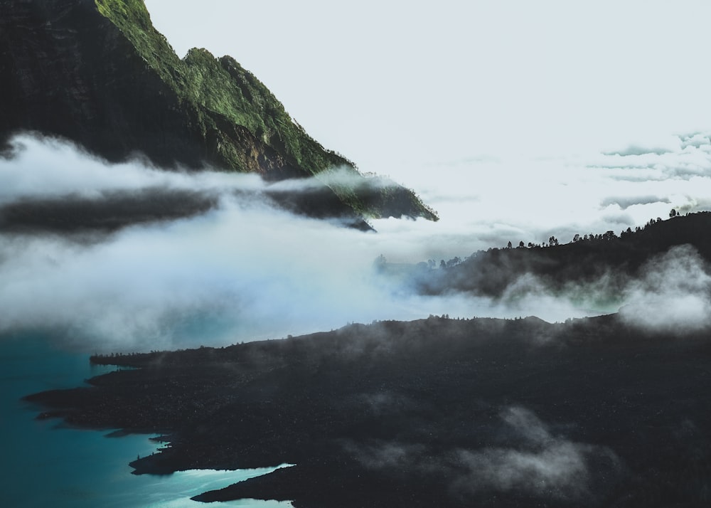 aerial photo of mountain near body of water during daytime