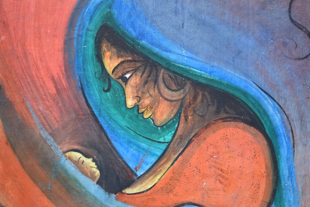 A stylized depiction of a woman with a serene expression gazes lovingly at a child nestled in her arms. Bold, vibrant colors create a sense of warmth and intimacy, with swirling lines outlining the figures.
