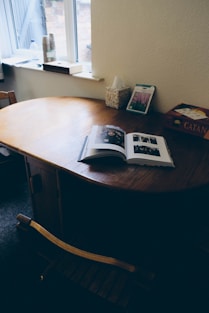 A cozy scene of a parent and child reading the Parenting Insight magazine together at a sunlit kitchen table.