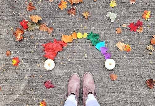 person wearing brown boots standing near leaves
