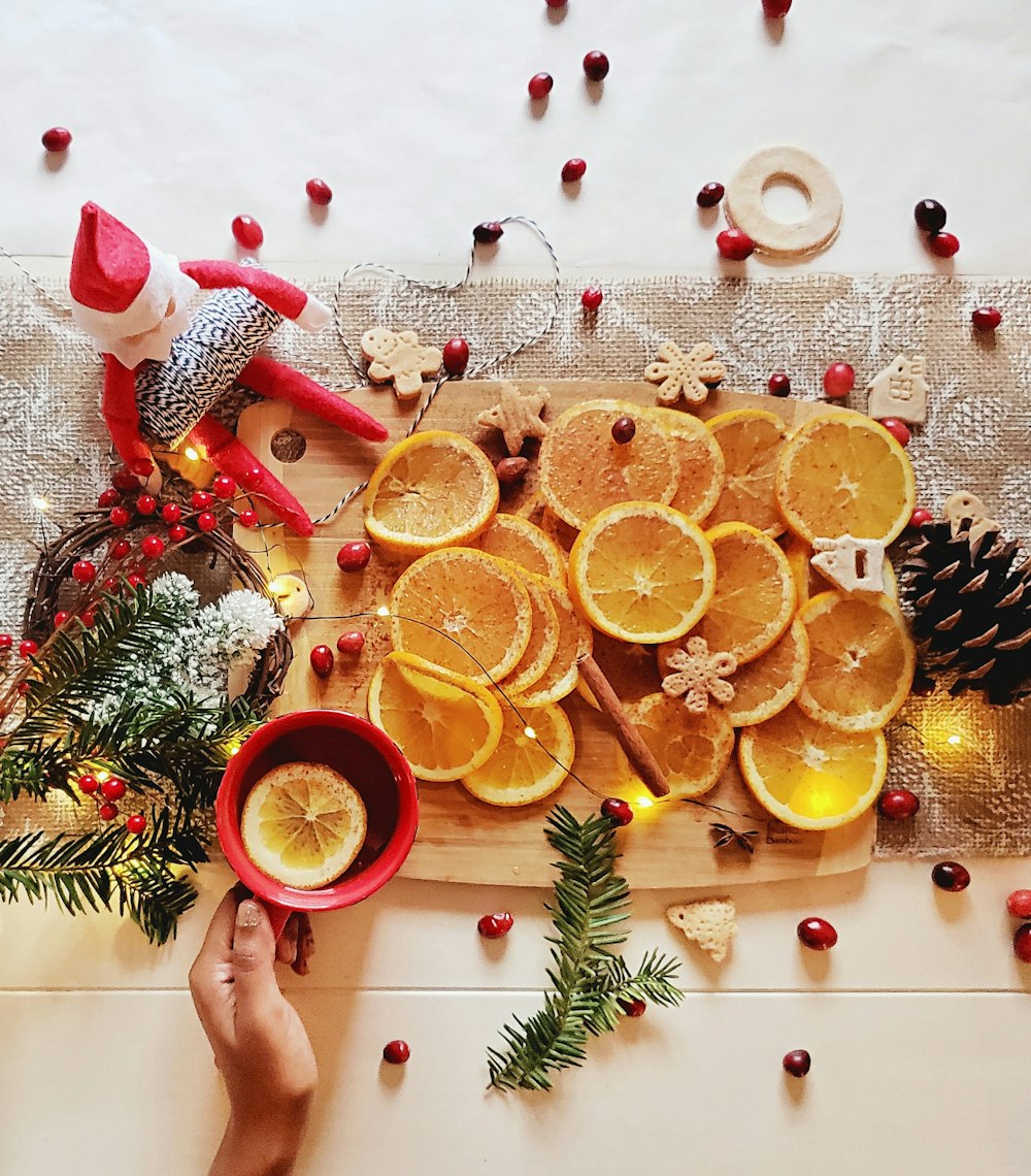 slice orange fruit on brown wooden chopping board