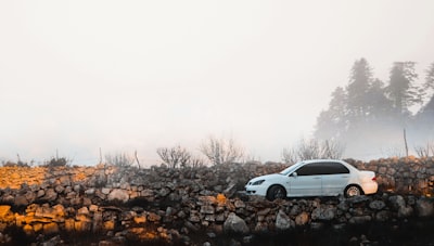 white pontiac sedan parked near rock formation palestine zoom background