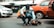 man sitting on street holding guitar