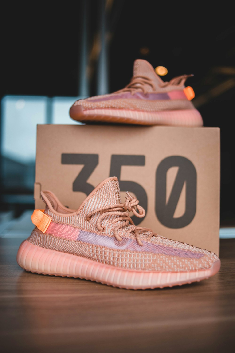 pair of pink Adidas Yeezy Boost 350 on brown wooden surface photo – Free  Image on Unsplash