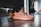 Close-up of trendy sneakers and casual clothing laid out on a wooden floor.