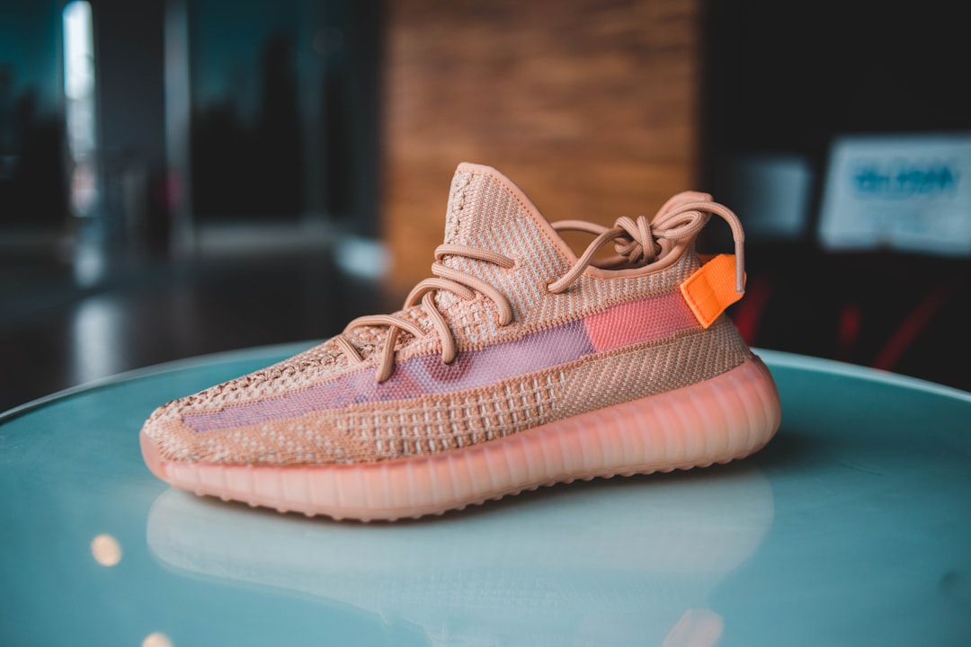 unpaired pink Adidas Yeezy Boost sneaker