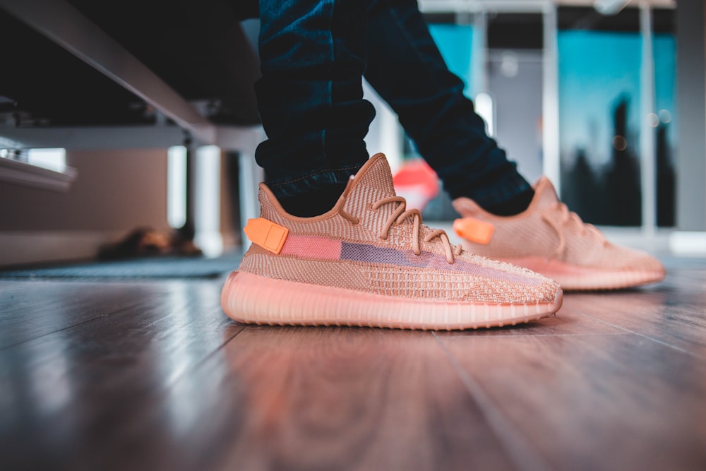 Person wears clay adidas yeezy boost 350 v2 photo – Free Apparel Image on  Unsplash
