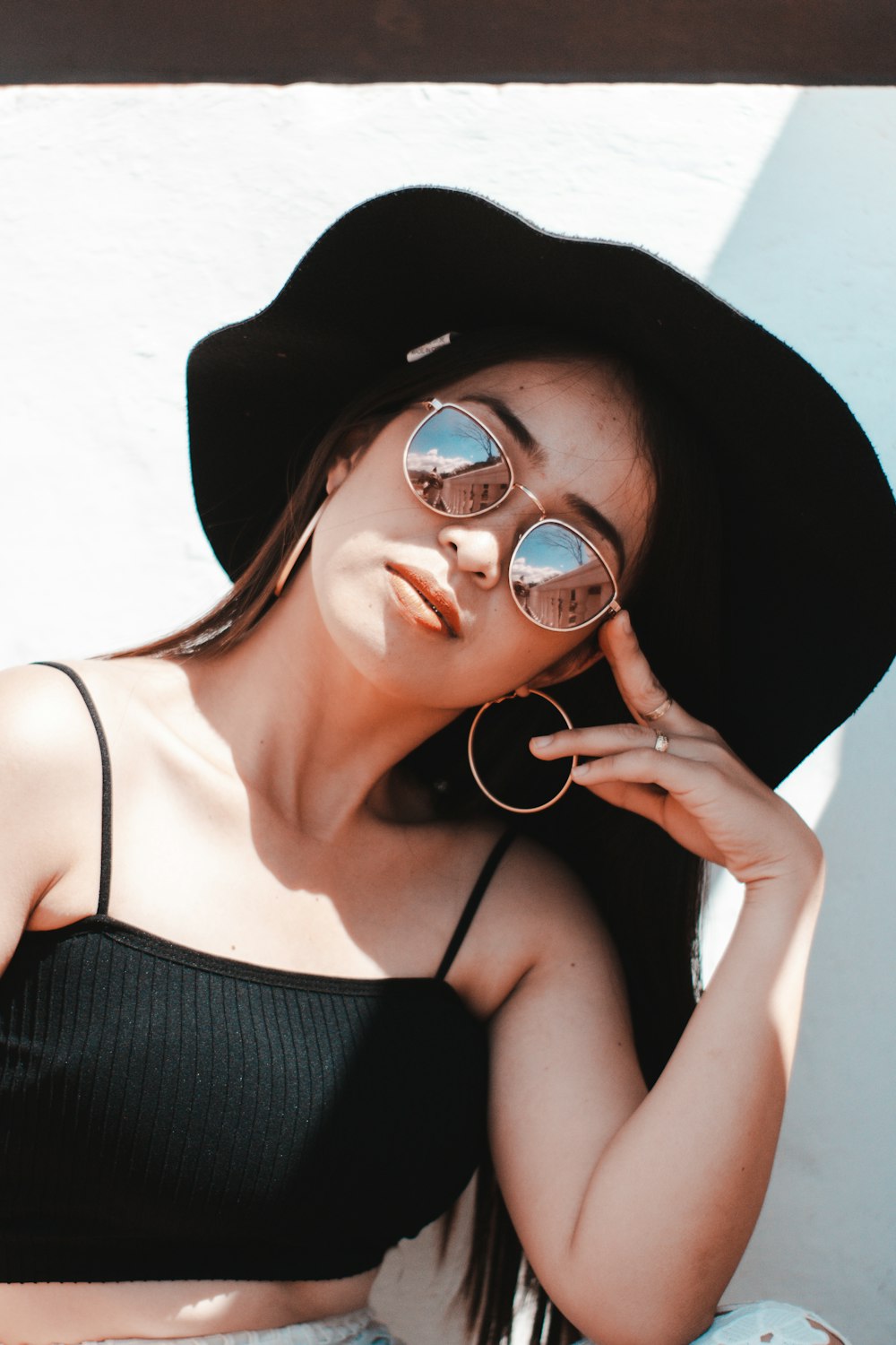 a woman wearing a black hat and sunglasses