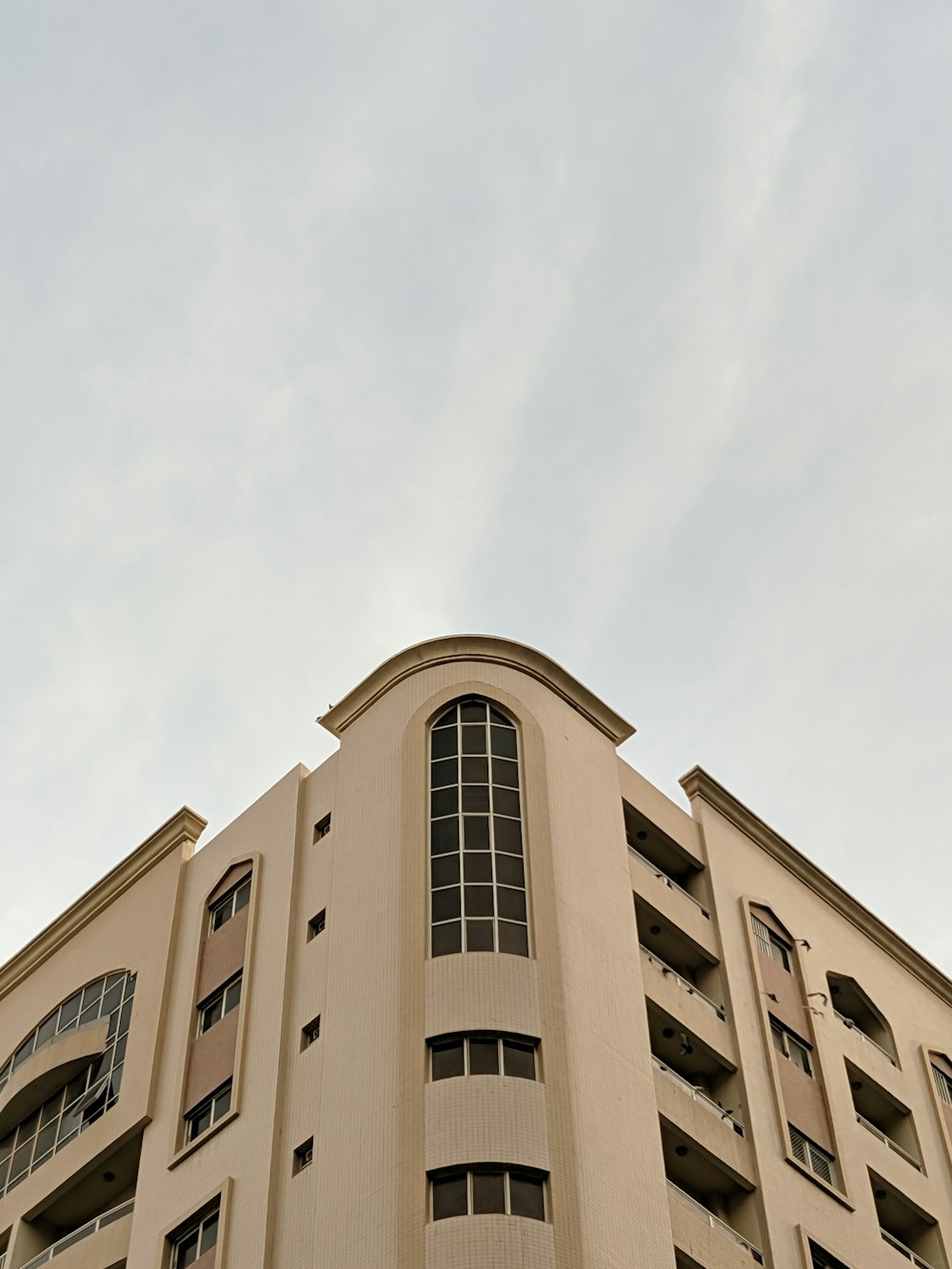 low-angle photography of white high-rise building