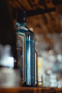 A cozy store shelf filled with assorted colorful beverage bottles under warm lighting