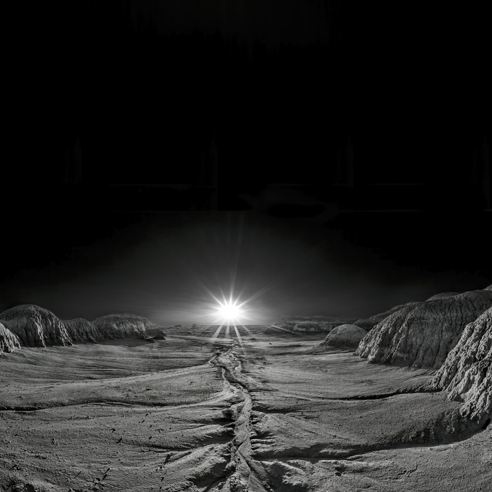 a black and white photo of a road in the desert