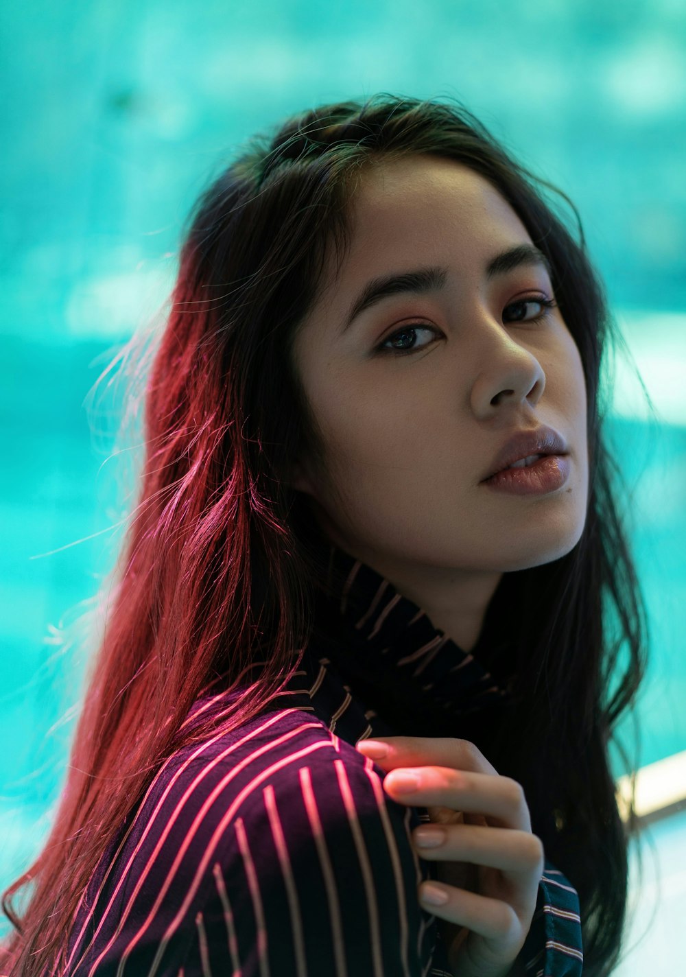 woman in purple and pink striped collared shirt