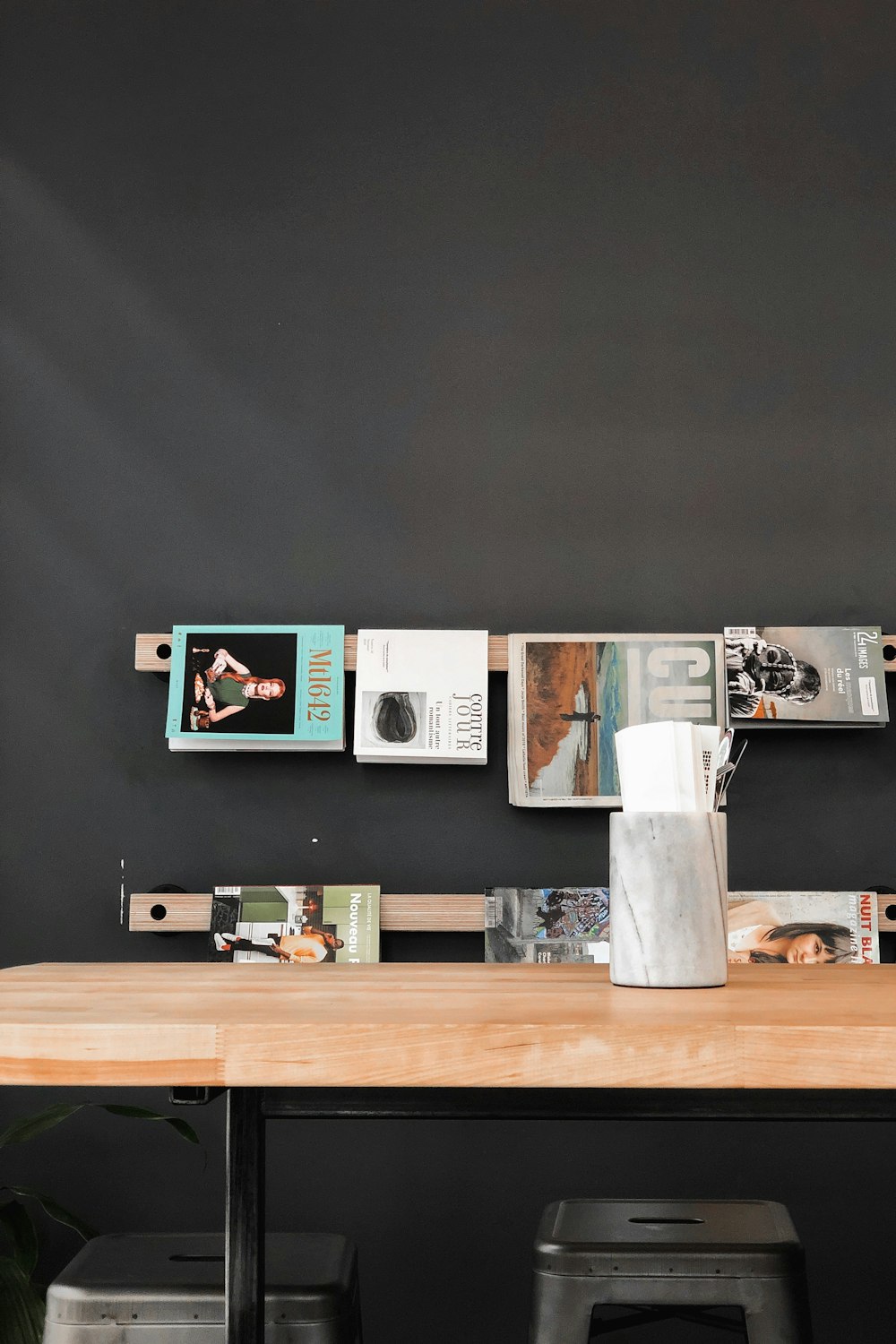 books and magazines hanged over wooden table