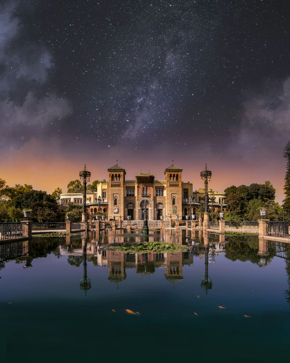 Ein großes Gebäude, das auf einem See unter einem Nachthimmel sitzt