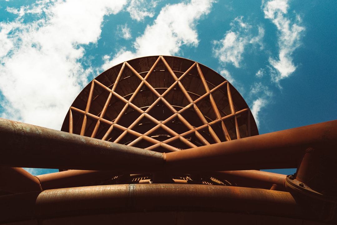 a large metal object with a sky background,