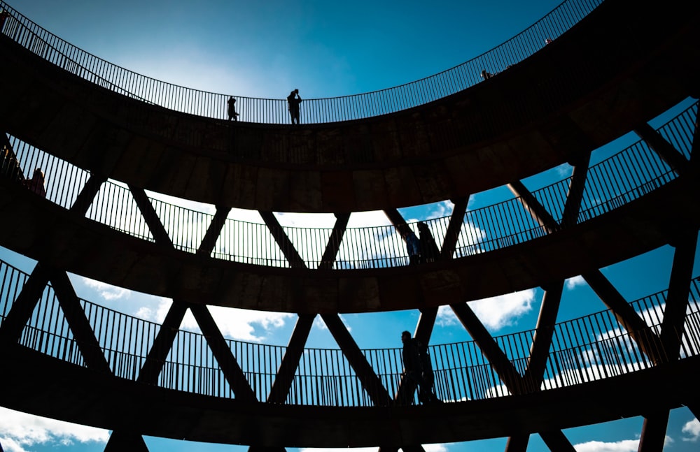 a person walking across a bridge with a sky background