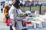 Close-up of hands exchanging books at a community book swap event.