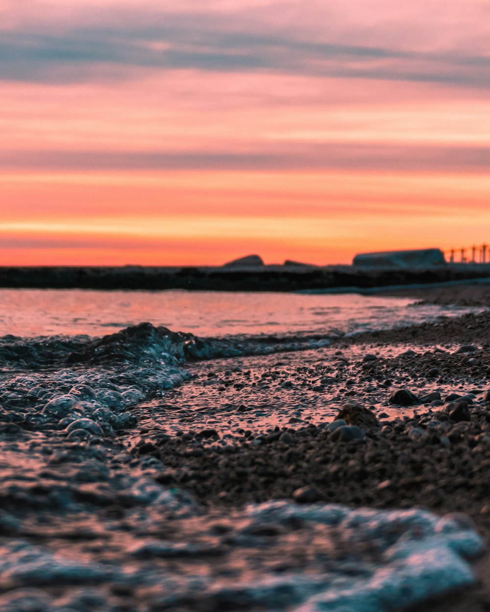 seashore and beach dock under orange skies