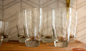 Colorful sublimation tumblers arranged on a wooden table with natural light.