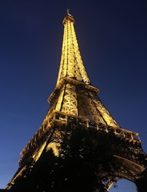 Iconic Eiffel Tower lit up against a twilight sky in Paris.