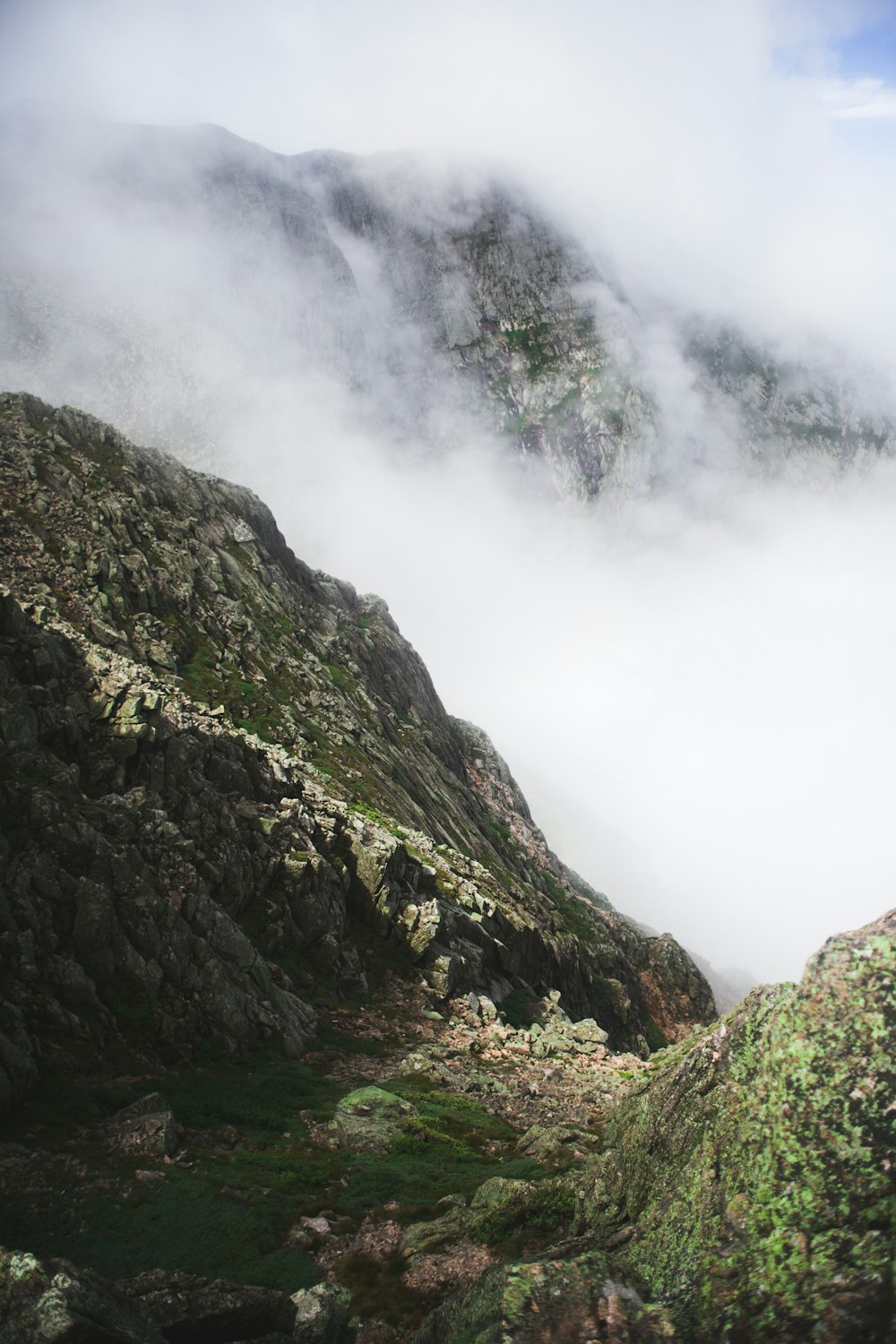 green mountains covered with fog