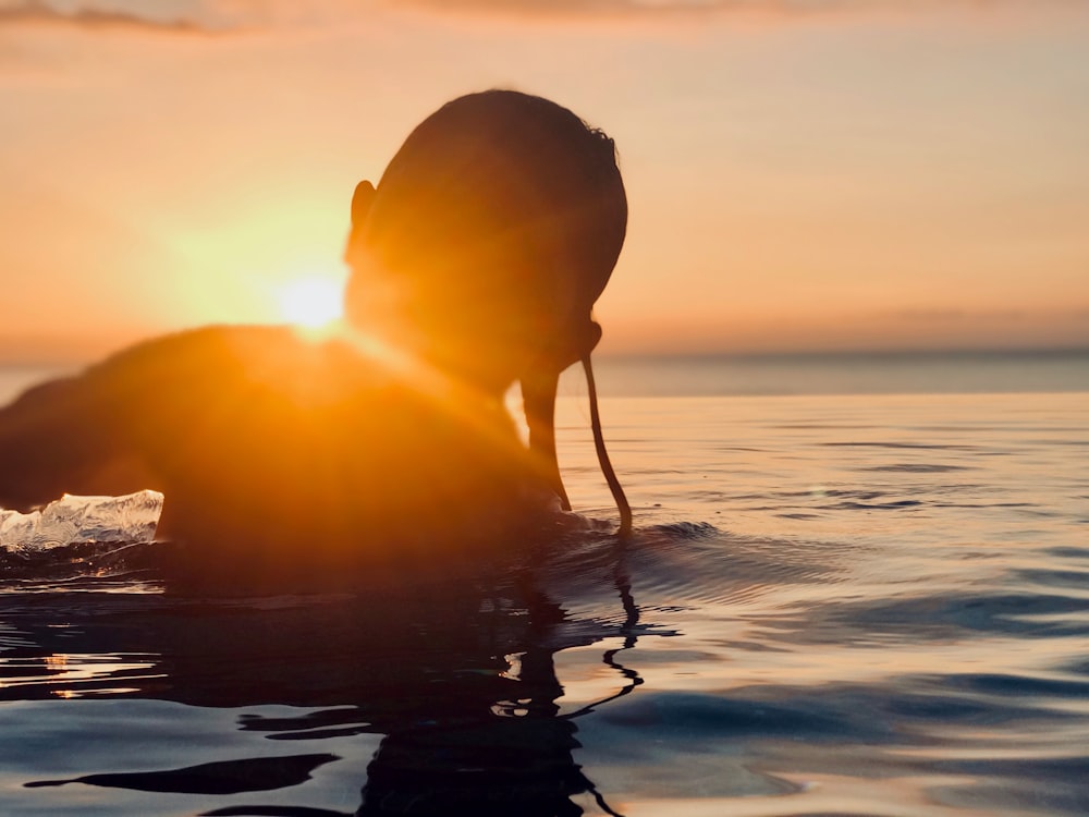 person in body of water during daytime