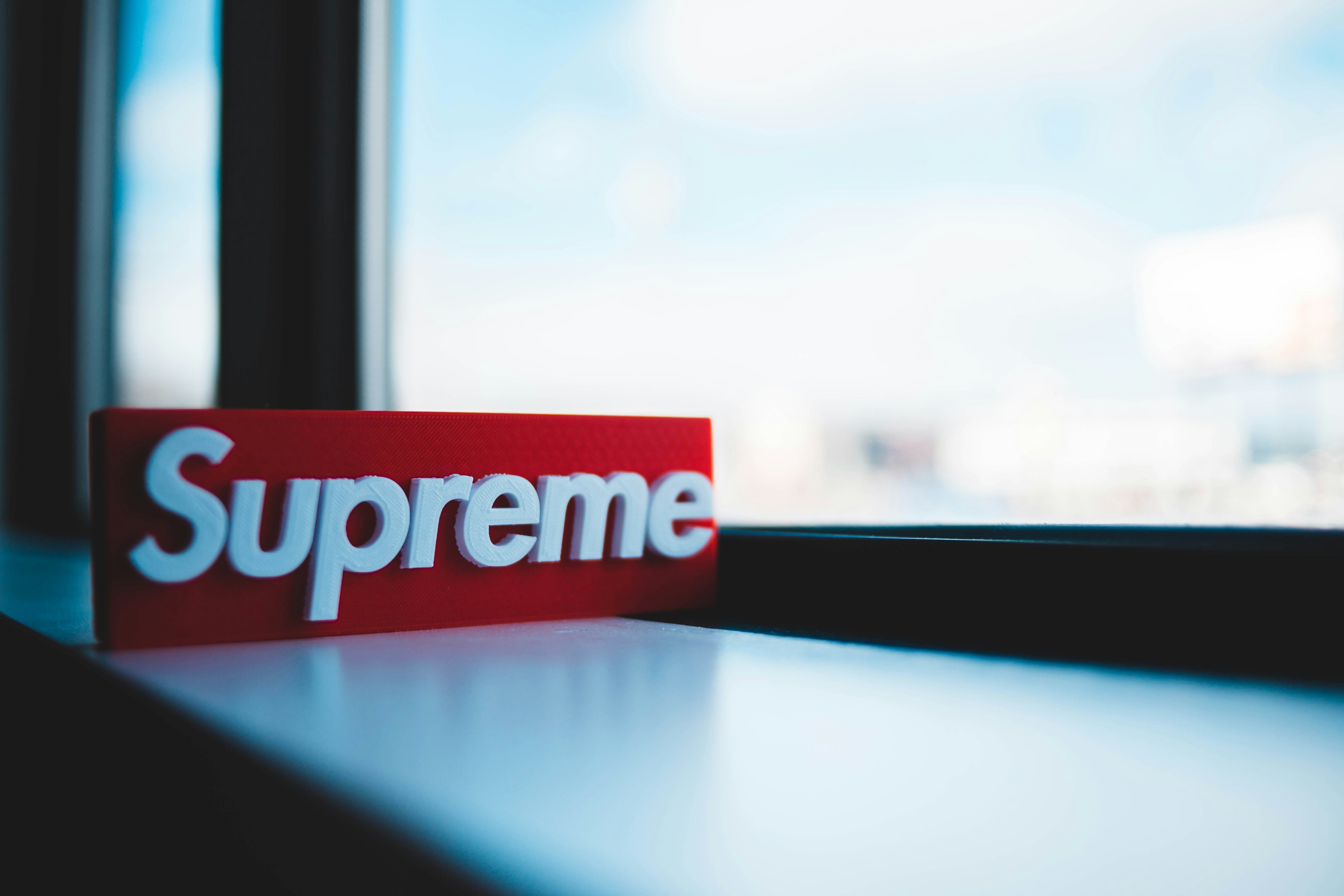 supreme signage near clear glass window