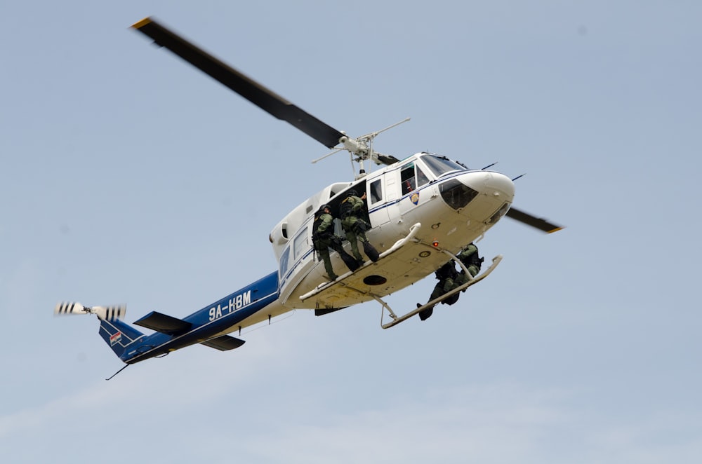 several persons on helicopter rail on air