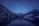 A serene landscape with a starry night sky over a calm lake.
