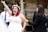 A joyful bride holding a wedding planner, surrounded by flowers and wedding decorations.
