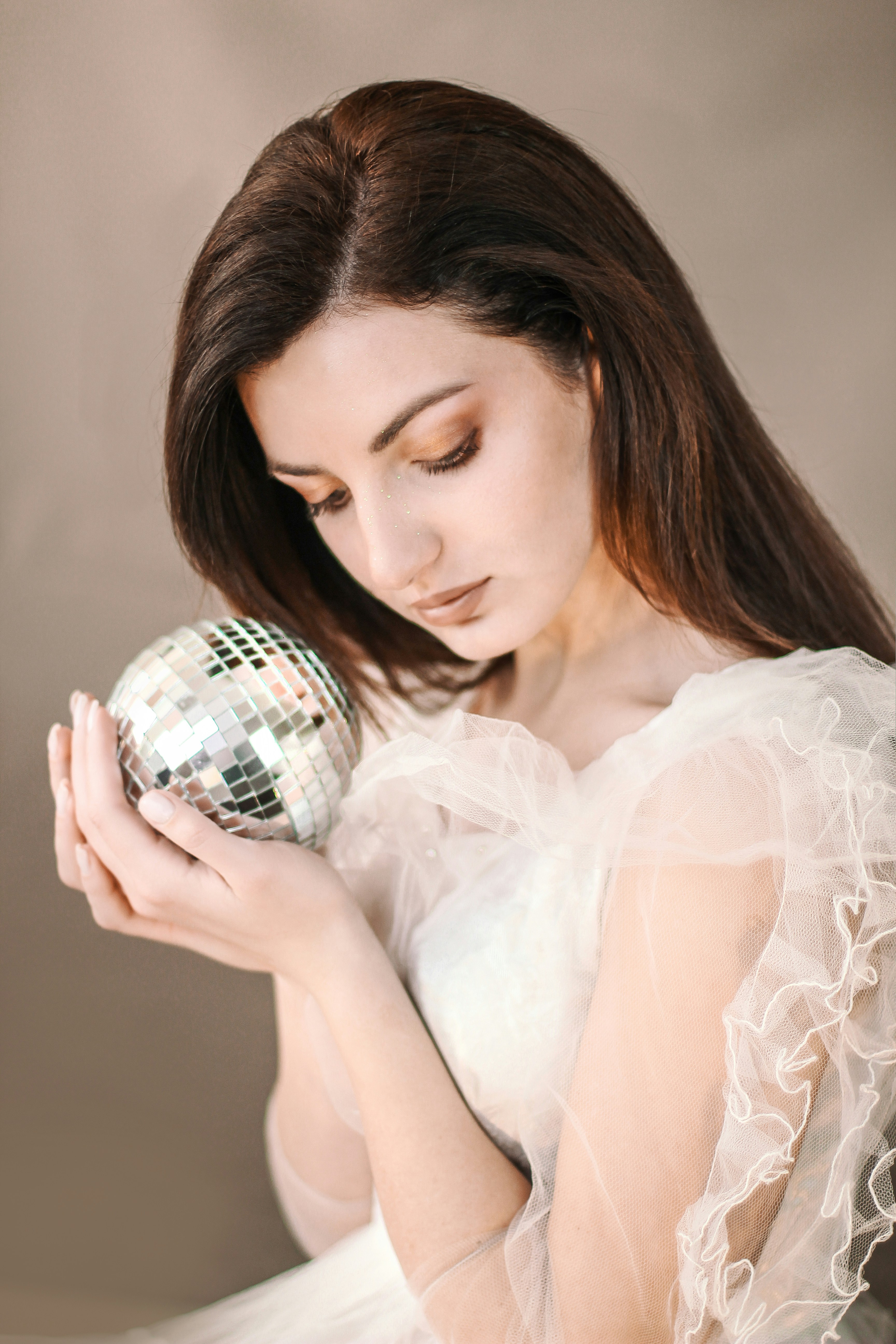 woman holding silver disco ball