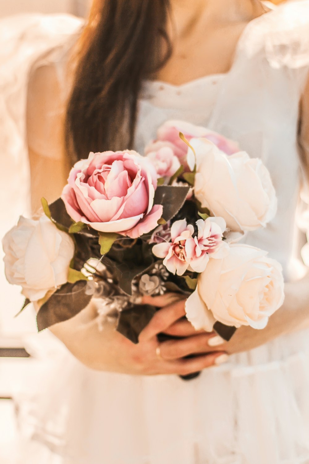 person holding pink flower bouquet