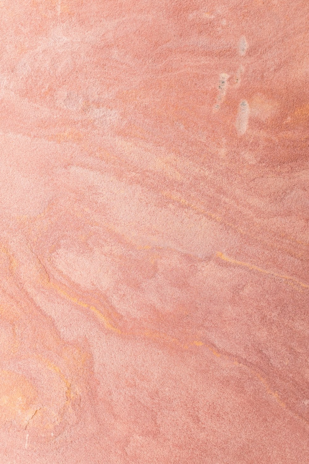 a skateboarder is riding on a pink surface