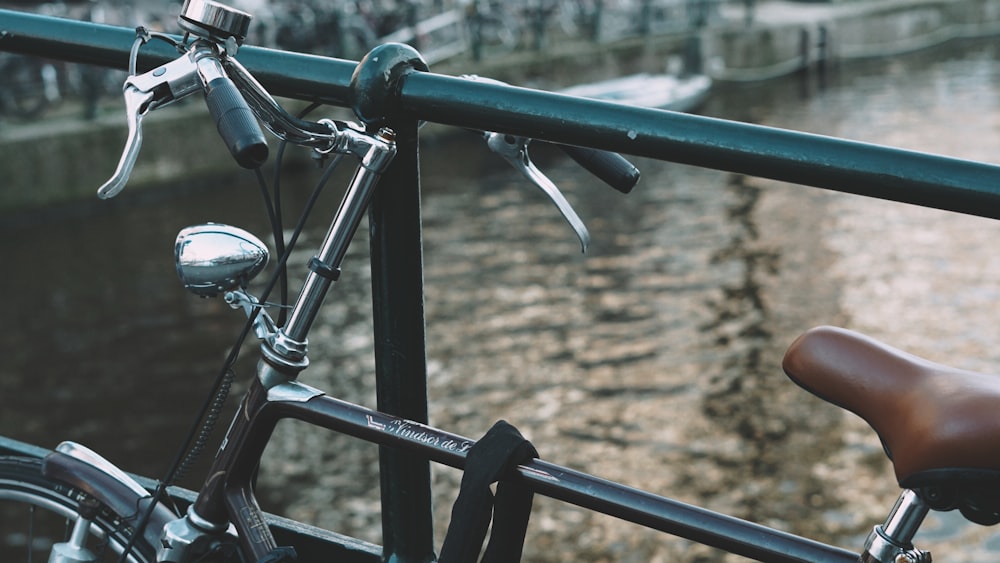 gray and black bicycle leaning on railing