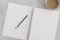black pencil on white notebook
