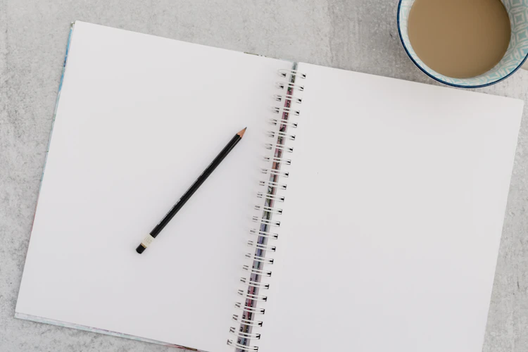 Black pencil on white notebook