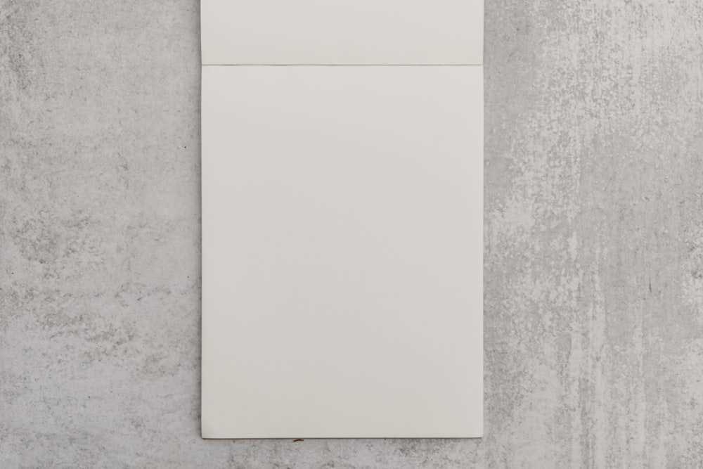 a white piece of paper sitting on top of a wall