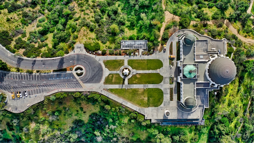 aerial photography of highrise building surrounded with green trees during daytime