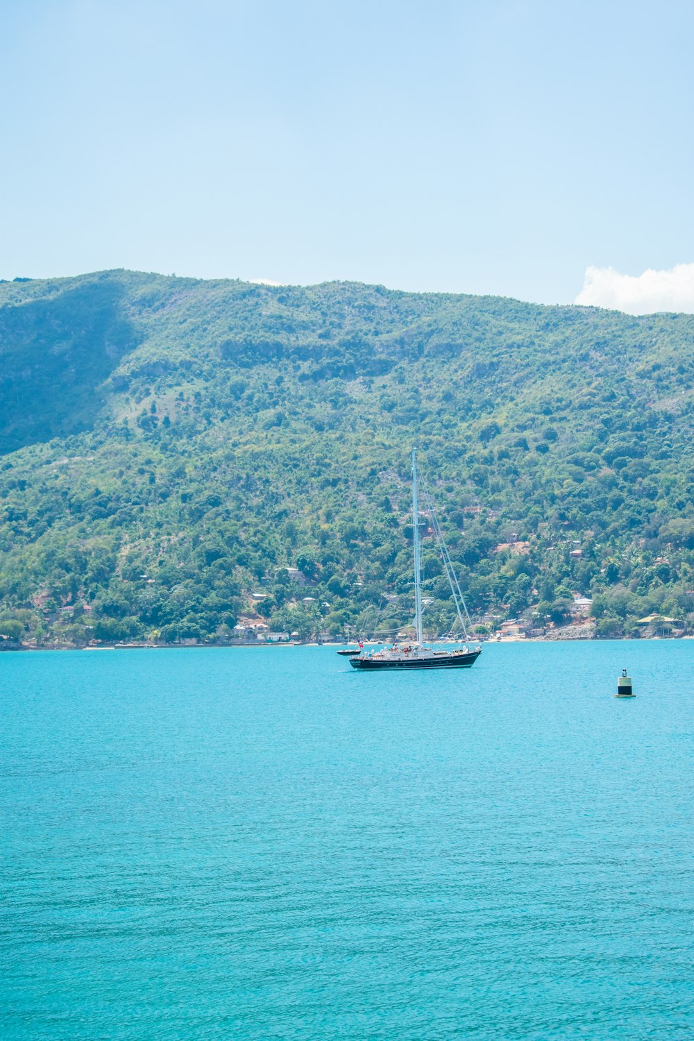 black and white boat on calm water at daytime