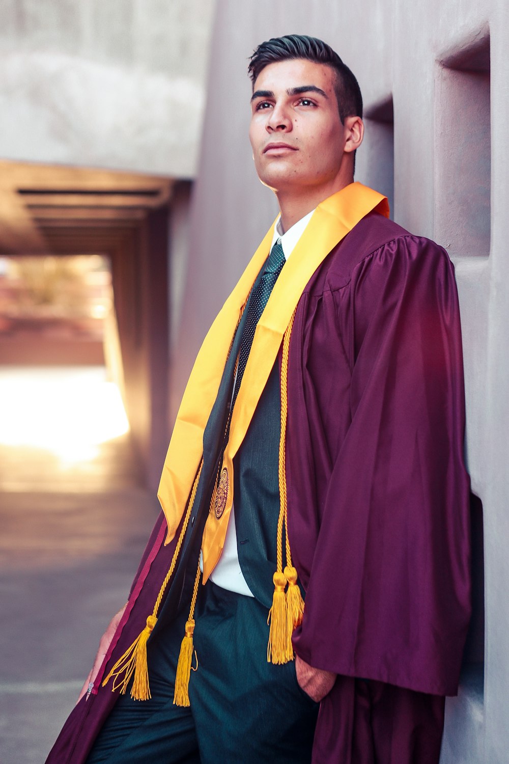 man standing while wearing purple academic gown
